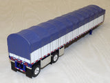 #60-2057 1/64 White & Blue Peterbilt Model 352 COE 110" Sleeper & 53' Wilson Roadbrute Flatbed Spread-Axle Trailer with Covered Wagon